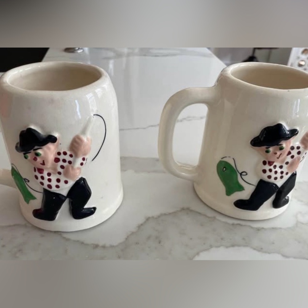 Vintage Pfaltzgraff "Muggsy" mugs depicting the "Rodney Reel" fishing design